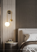 Load image into Gallery viewer, INSPIRA LIFESTYLES - Gentry Wall Sconce, postmodern dual globe wall light, frosted glass wall sconce, contemporary bedside wall lighting, sculptural architectural wall lamp, luxury modern wall light in brass finish