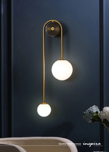 Load image into Gallery viewer, INSPIRA LIFESTYLES - Gentry Wall Sconce, postmodern dual globe wall light, frosted glass wall sconce, contemporary bedside wall lighting, sculptural architectural wall lamp, luxury modern wall light in brass finish