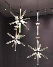 Load image into Gallery viewer, INSPIRA LIFESTYLES | Asterisk Light Sculptural glass pendant light with striped pattern from the Asterisk Light Series, cluster of tubular glass pendants forming a chandelier over stairwell, single striped glass pendant light styled beside bed, modern glass table lamp with striped detailing from the Asterisk Series, floor lamp with sculptural glass shade and minimalist base, high ceiling lighting installation featuring Asterisk pendant cluster, close-up of striped glass tubing on contemporary pendant light.