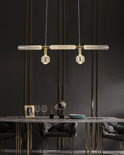 Load image into Gallery viewer, INSPIRA LIFESTYLES | Asterisk Light Sculptural glass pendant light with striped pattern from the Asterisk Light Series, cluster of tubular glass pendants forming a chandelier over stairwell, single striped glass pendant light styled beside bed, modern glass table lamp with striped detailing from the Asterisk Series, floor lamp with sculptural glass shade and minimalist base, high ceiling lighting installation featuring Asterisk pendant cluster, close-up of striped glass tubing on contemporary pendant light.