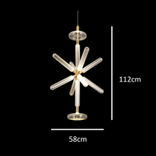 Load image into Gallery viewer, INSPIRA LIFESTYLES | Asterisk Light Sculptural glass pendant light with striped pattern from the Asterisk Light Series, cluster of tubular glass pendants forming a chandelier over stairwell, single striped glass pendant light styled beside bed, modern glass table lamp with striped detailing from the Asterisk Series, floor lamp with sculptural glass shade and minimalist base, high ceiling lighting installation featuring Asterisk pendant cluster, close-up of striped glass tubing on contemporary pendant light.