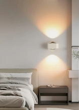 Load image into Gallery viewer, Inspira Lifestyles | Chiaro Wall Sconce with clear glass globe and minimalist Italian design, black/gold/white finish, featuring soft ambient up-and-down LED lighting, ideal for modern living rooms, bedrooms, hallways, and commercial interiors.