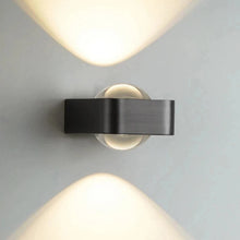 Load image into Gallery viewer, Inspira Lifestyles | Chiaro Wall Sconce with clear glass globe and minimalist Italian design, black/gold/white finish, featuring soft ambient up-and-down LED lighting, ideal for modern living rooms, bedrooms, hallways, and commercial interiors.
