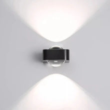 Load image into Gallery viewer, Inspira Lifestyles | Chiaro Wall Sconce with clear glass globe and minimalist Italian design, black/gold/white finish, featuring soft ambient up-and-down LED lighting, ideal for modern living rooms, bedrooms, hallways, and commercial interiors.