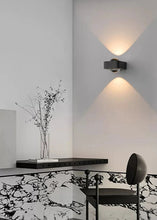 Load image into Gallery viewer, Inspira Lifestyles | Chiaro Wall Sconce with clear glass globe and minimalist Italian design, black/gold/white finish, featuring soft ambient up-and-down LED lighting, ideal for modern living rooms, bedrooms, hallways, and commercial interiors.