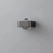 Load image into Gallery viewer, Inspira Lifestyles | Chiaro Wall Sconce with clear glass globe and minimalist Italian design, black/gold/white finish, featuring soft ambient up-and-down LED lighting, ideal for modern living rooms, bedrooms, hallways, and commercial interiors.
