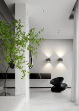Load image into Gallery viewer, Inspira Lifestyles | Chiaro Wall Sconce with clear glass globe and minimalist Italian design, black/gold/white finish, featuring soft ambient up-and-down LED lighting, ideal for modern living rooms, bedrooms, hallways, and commercial interiors.