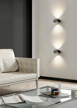 Load image into Gallery viewer, Inspira Lifestyles | Chiaro Wall Sconce with clear glass globe and minimalist Italian design, black/gold/white finish, featuring soft ambient up-and-down LED lighting, ideal for modern living rooms, bedrooms, hallways, and commercial interiors.