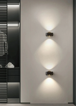 Load image into Gallery viewer, Inspira Lifestyles | Chiaro Wall Sconce with clear glass globe and minimalist Italian design, black/gold/white finish, featuring soft ambient up-and-down LED lighting, ideal for modern living rooms, bedrooms, hallways, and commercial interiors.