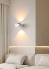 Load image into Gallery viewer, Inspira Lifestyles | Chiaro Wall Sconce with clear glass globe and minimalist Italian design, black/gold/white finish, featuring soft ambient up-and-down LED lighting, ideal for modern living rooms, bedrooms, hallways, and commercial interiors.