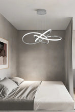 Load image into Gallery viewer, INSPIRA LIFESTYLES | Helia Twisted Pendant Light in chrome, polished gold, and matte black finishes, featuring a sculptural ribbon-like design, suspended with near-invisible wires to create a floating effect, perfect for modern interiors, dining rooms, stairwells, and contemporary living spaces, stylish lighting fixture, luxury pendant light, ambient illumination, contemporary ceiling lighting. Modern Chandelier, Minimalist Chandelier, Sculptural light, Dining table light, Living room light, LED Pendant