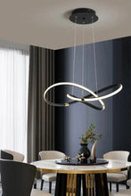 Load image into Gallery viewer, INSPIRA LIFESTYLES | Helia Twisted Pendant Light in chrome, polished gold, and matte black finishes, featuring a sculptural ribbon-like design, suspended with near-invisible wires to create a floating effect, perfect for modern interiors, dining rooms, stairwells, and contemporary living spaces, stylish lighting fixture, luxury pendant light, ambient illumination, contemporary ceiling lighting. Modern Chandelier, Minimalist Chandelier, Sculptural light, Dining table light, Living room light, LED Pendant