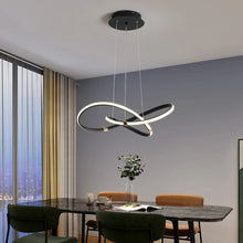 Load image into Gallery viewer, INSPIRA LIFESTYLES | Helia Twisted Pendant Light in chrome, polished gold, and matte black finishes, featuring a sculptural ribbon-like design, suspended with near-invisible wires to create a floating effect, perfect for modern interiors, dining rooms, stairwells, and contemporary living spaces, stylish lighting fixture, luxury pendant light, ambient illumination, contemporary ceiling lighting. Modern Chandelier, Minimalist Chandelier, Sculptural light, Dining table light, Living room light, LED Pendant
