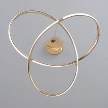 Load image into Gallery viewer, INSPIRA LIFESTYLES | Helia Twisted Pendant Light in chrome, polished gold, and matte black finishes, featuring a sculptural ribbon-like design, suspended with near-invisible wires to create a floating effect, perfect for modern interiors, dining rooms, stairwells, and contemporary living spaces, stylish lighting fixture, luxury pendant light, ambient illumination, contemporary ceiling lighting. Modern Chandelier, Minimalist Chandelier, Sculptural light, Dining table light, Living room light, LED Pendant