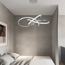 Load image into Gallery viewer, INSPIRA LIFESTYLES | Helia Twisted Pendant Light in chrome, polished gold, and matte black finishes, featuring a sculptural ribbon-like design, suspended with near-invisible wires to create a floating effect, perfect for modern interiors, dining rooms, stairwells, and contemporary living spaces, stylish lighting fixture, luxury pendant light, ambient illumination, contemporary ceiling lighting. Modern Chandelier, Minimalist Chandelier, Sculptural light, Dining table light, Living room light, LED Pendant