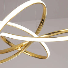 Load image into Gallery viewer, INSPIRA LIFESTYLES | Helia Twisted Pendant Light in chrome, polished gold, and matte black finishes, featuring a sculptural ribbon-like design, suspended with near-invisible wires to create a floating effect, perfect for modern interiors, dining rooms, stairwells, and contemporary living spaces, stylish lighting fixture, luxury pendant light, ambient illumination, contemporary ceiling lighting. Modern Chandelier, Minimalist Chandelier, Sculptural light, Dining table light, Living room light, LED Pendant