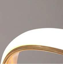 Load image into Gallery viewer, INSPIRA LIFESTYLES | Helia Twisted Pendant Light in chrome, polished gold, and matte black finishes, featuring a sculptural ribbon-like design, suspended with near-invisible wires to create a floating effect, perfect for modern interiors, dining rooms, stairwells, and contemporary living spaces, stylish lighting fixture, luxury pendant light, ambient illumination, contemporary ceiling lighting. Modern Chandelier, Minimalist Chandelier, Sculptural light, Dining table light, Living room light, LED Pendant