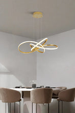 Load image into Gallery viewer, INSPIRA LIFESTYLES | Helia Twisted Pendant Light in chrome, polished gold, and matte black finishes, featuring a sculptural ribbon-like design, suspended with near-invisible wires to create a floating effect, perfect for modern interiors, dining rooms, stairwells, and contemporary living spaces, stylish lighting fixture, luxury pendant light, ambient illumination, contemporary ceiling lighting. Modern Chandelier, Minimalist Chandelier, Sculptural light, Dining table light, Living room light, LED Pendant