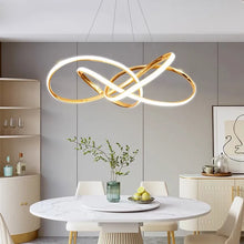 Load image into Gallery viewer, INSPIRA LIFESTYLES | Helia Twisted Pendant Light in chrome, polished gold, and matte black finishes, featuring a sculptural ribbon-like design, suspended with near-invisible wires to create a floating effect, perfect for modern interiors, dining rooms, stairwells, and contemporary living spaces, stylish lighting fixture, luxury pendant light, ambient illumination, contemporary ceiling lighting. Modern Chandelier, Minimalist Chandelier, Sculptural light, Dining table light, Living room light, LED Pendant