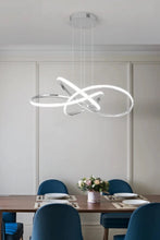 Load image into Gallery viewer, INSPIRA LIFESTYLES | Helia Twisted Pendant Light in chrome, polished gold, and matte black finishes, featuring a sculptural ribbon-like design, suspended with near-invisible wires to create a floating effect, perfect for modern interiors, dining rooms, stairwells, and contemporary living spaces, stylish lighting fixture, luxury pendant light, ambient illumination, contemporary ceiling lighting. Modern Chandelier, Minimalist Chandelier, Sculptural light, Dining table light, Living room light, LED Pendant