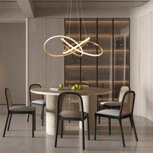 Load image into Gallery viewer, INSPIRA LIFESTYLES | Helia Twisted Pendant Light in chrome, polished gold, and matte black finishes, featuring a sculptural ribbon-like design, suspended with near-invisible wires to create a floating effect, perfect for modern interiors, dining rooms, stairwells, and contemporary living spaces, stylish lighting fixture, luxury pendant light, ambient illumination, contemporary ceiling lighting. Modern Chandelier, Minimalist Chandelier, Sculptural light, Dining table light, Living room light, LED Pendant