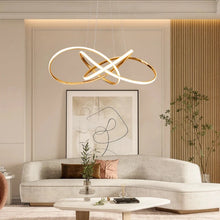 Load image into Gallery viewer, INSPIRA LIFESTYLES | Helia Twisted Pendant Light in chrome, polished gold, and matte black finishes, featuring a sculptural ribbon-like design, suspended with near-invisible wires to create a floating effect, perfect for modern interiors, dining rooms, stairwells, and contemporary living spaces, stylish lighting fixture, luxury pendant light, ambient illumination, contemporary ceiling lighting. Modern Chandelier, Minimalist Chandelier, Sculptural light, Dining table light, Living room light, LED Pendant