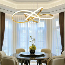 Load image into Gallery viewer, INSPIRA LIFESTYLES | Helia Twisted Pendant Light in chrome, polished gold, and matte black finishes, featuring a sculptural ribbon-like design, suspended with near-invisible wires to create a floating effect, perfect for modern interiors, dining rooms, stairwells, and contemporary living spaces, stylish lighting fixture, luxury pendant light, ambient illumination, contemporary ceiling lighting. Modern Chandelier, Minimalist Chandelier, Sculptural light, Dining table light, Living room light, LED Pendant