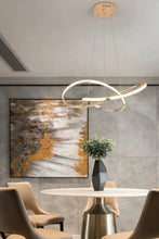 Load image into Gallery viewer, INSPIRA LIFESTYLES | Helia Twisted Pendant Light in chrome, polished gold, and matte black finishes, featuring a sculptural ribbon-like design, suspended with near-invisible wires to create a floating effect, perfect for modern interiors, dining rooms, stairwells, and contemporary living spaces, stylish lighting fixture, luxury pendant light, ambient illumination, contemporary ceiling lighting. Modern Chandelier, Minimalist Chandelier, Sculptural light, Dining table light, Living room light, LED Pendant