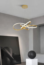 Load image into Gallery viewer, INSPIRA LIFESTYLES | Helia Twisted Pendant Light in chrome, polished gold, and matte black finishes, featuring a sculptural ribbon-like design, suspended with near-invisible wires to create a floating effect, perfect for modern interiors, dining rooms, stairwells, and contemporary living spaces, stylish lighting fixture, luxury pendant light, ambient illumination, contemporary ceiling lighting. Modern Chandelier, Minimalist Chandelier, Sculptural light, Dining table light, Living room light, LED Pendant