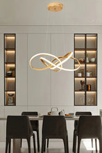 Load image into Gallery viewer, INSPIRA LIFESTYLES | Helia Twisted Pendant Light in chrome, polished gold, and matte black finishes, featuring a sculptural ribbon-like design, suspended with near-invisible wires to create a floating effect, perfect for modern interiors, dining rooms, stairwells, and contemporary living spaces, stylish lighting fixture, luxury pendant light, ambient illumination, contemporary ceiling lighting. Modern Chandelier, Minimalist Chandelier, Sculptural light, Dining table light, Living room light, LED Pendant
