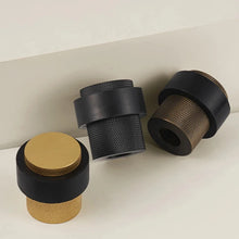 Load image into Gallery viewer, INSPIRA LIFESTYLES - Knurled Floor Door Stops featuring a crisscross diamond knurled pattern and protective rubber bumpers in Matte Black, Satin Brass and Antique Bronze.