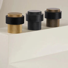 Load image into Gallery viewer, INSPIRA LIFESTYLES - Knurled Floor Door Stops featuring a crisscross diamond knurled pattern and protective rubber bumpers in Matte Black, Satin Brass and Antique Bronze.