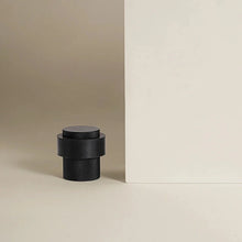 Load image into Gallery viewer, INSPIRA LIFESTYLES - Knurled Floor Door Stops featuring a crisscross diamond knurled pattern and protective rubber bumpers in Matte Black, Satin Brass and Antique Bronze.