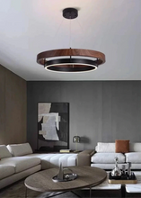 Load image into Gallery viewer, INSPIRA LIFESTYLES – Anello Duo Chandelier – sculptural two-tier chandelier with wood-patterned ring and matte black ring. Modern LED light fixture for dining rooms, living rooms, stairwells, offices, and transitional interiors.