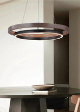 Load image into Gallery viewer, INSPIRA LIFESTYLES – Anello Duo Chandelier – sculptural two-tier chandelier with wood-patterned ring and matte black ring. Modern LED light fixture for dining rooms, living rooms, stairwells, offices, and transitional interiors.