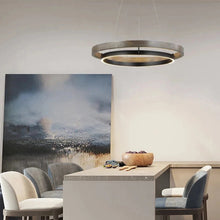 Load image into Gallery viewer, INSPIRA LIFESTYLES – Anello Duo Chandelier – sculptural two-tier chandelier with wood-patterned ring and matte black ring. Modern LED light fixture for dining rooms, living rooms, stairwells, offices, and transitional interiors.