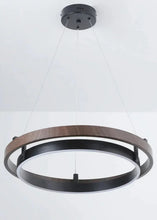 Load image into Gallery viewer, INSPIRA LIFESTYLES – Anello Duo Chandelier – sculptural two-tier chandelier with wood-patterned ring and matte black ring. Modern LED light fixture for dining rooms, living rooms, stairwells, offices, and transitional interiors.