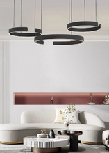 Load image into Gallery viewer, INSPIRA LIFESTYLES – Cuff Circular Pendant, modern ring chandelier in rose gold, gold, black, and white, minimalist circular LED pendant light for dining rooms, conference rooms, double-height spaces, and contemporary interiors