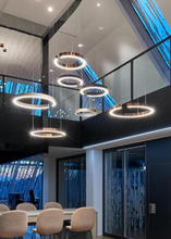 Load image into Gallery viewer, INSPIRA LIFESTYLES – Cuff Circular Pendant, modern ring chandelier in rose gold, gold, black, and white, minimalist circular LED pendant light for dining rooms, conference rooms, double-height spaces, and contemporary interiors