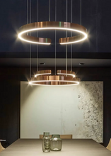 Load image into Gallery viewer, INSPIRA LIFESTYLES – Cuff Circular Pendant, modern ring chandelier in rose gold, gold, black, and white, minimalist circular LED pendant light for dining rooms, conference rooms, double-height spaces, and contemporary interiors