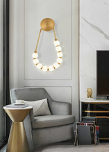 Load image into Gallery viewer, INSPIRA LIFESTYLES - Milli Wall Light, LED wall sconce, frosted globe lighting, sculptural wall lamp, bedroom wall light, living room accent lighting, modern wall sconce, hallway lighting, designer wall fixture, minimalist lighting design, contemporary wall decor, luxury LED light.