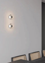 Load image into Gallery viewer, Inspira Lifestyles | Onda Crystal Wall Light with round optical crystal disc and chrome center, mounted as a modern LED wall or ceiling sconce.