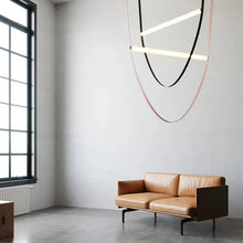 Load image into Gallery viewer, Parabola Belt Pendant | INSPIRA LIFESTYLES - Modern Minimalist Belt Pendant Lamp for high ceilings, Glass Tube Pendant Light, Creative LED Lighting Fixture, Living Room Pendant Light, Duplex Villa Pendant Lamp, Staircase Lighting Pendant, Minimalist Glass Tube Lamp, Contemporary LED Pendant Light, Elegant Belt Pendant Lamp, Stylish Modern Lighting, High-End Glass Pendant Light, Modern Living Room Illumination, Chic Duplex Villa Lamp, leather pendant light, industrial modern lighting