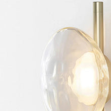 Load image into Gallery viewer, Inspira Lifestyles | Siro Wall Sconce with organic textured glass mounted on a brushed metal base. Modern sculptural wall lamp light fixture for residential or commercial interiors