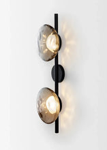 Load image into Gallery viewer, Inspira Lifestyles | Siro Wall Sconce with organic textured glass mounted on a brushed metal base. Modern sculptural wall lamp light fixture for residential or commercial interiors