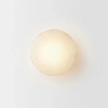 Load image into Gallery viewer, Inspira Lifestyles | Siro Wall Sconce with organic textured glass mounted on a brushed metal base. Modern sculptural wall lamp light fixture for residential or commercial interiors