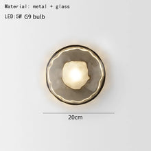 Load image into Gallery viewer, Inspira Lifestyles | Siro Wall Sconce with organic textured glass mounted on a brushed metal base. Modern sculptural wall lamp light fixture for residential or commercial interiors