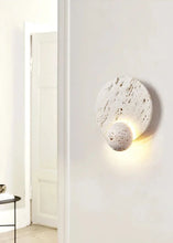 Load image into Gallery viewer, Inspira Lifestyles | Solace Travertine Wall Light – A natural travertine wall sconce designed to bring warmth, organic texture, and ambient lighting to contemporary interior spaces. Ideal as accent lighting in living rooms, bathrooms, stairwells, spas, and wellness-inspired environments. Natural stone wall lighting for both residential and commercial interiors.