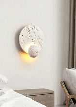 Load image into Gallery viewer, Inspira Lifestyles | Solace Travertine Wall Light – A natural travertine wall sconce designed to bring warmth, organic texture, and ambient lighting to contemporary interior spaces. Ideal as accent lighting in living rooms, bathrooms, stairwells, spas, and wellness-inspired environments. Natural stone wall lighting for both residential and commercial interiors.