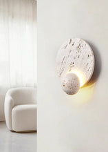 Load image into Gallery viewer, Inspira Lifestyles | Solace Travertine Wall Light – A natural travertine wall sconce designed to bring warmth, organic texture, and ambient lighting to contemporary interior spaces. Ideal as accent lighting in living rooms, bathrooms, stairwells, spas, and wellness-inspired environments. Natural stone wall lighting for both residential and commercial interiors.
